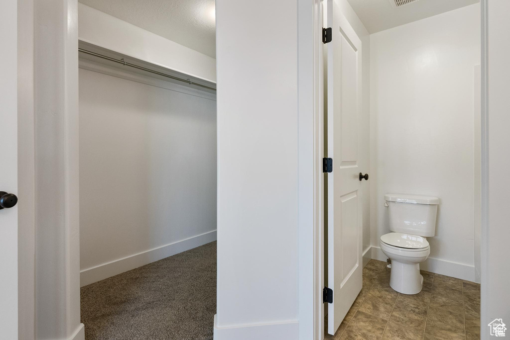 Bathroom with toilet and baseboards
