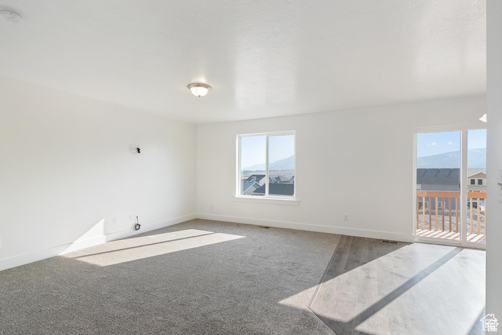 Spare room featuring baseboards and a smoke detector