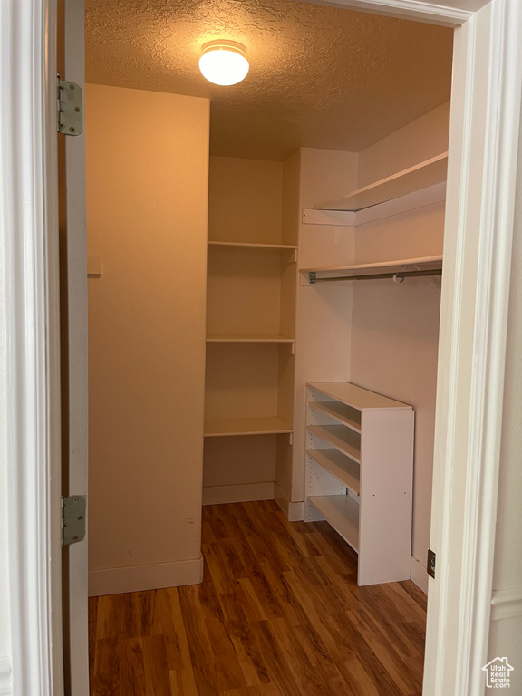 Walk in closet featuring wood finished floors