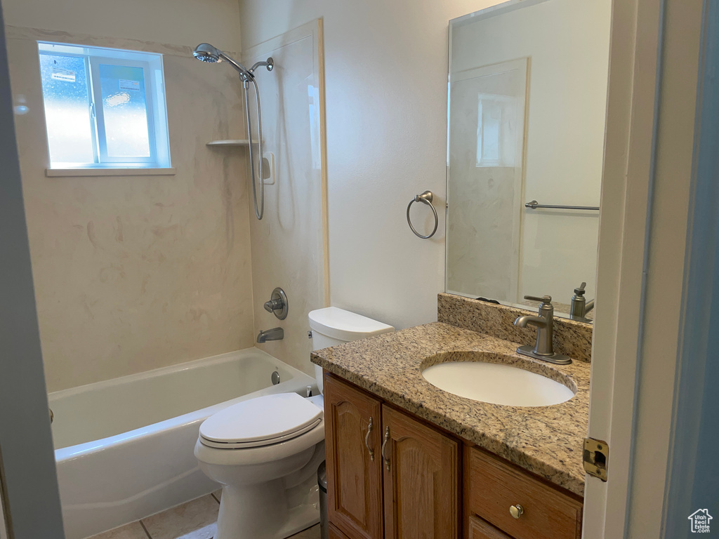 Full bath with toilet, vanity, bathtub / shower combination, and tile patterned flooring