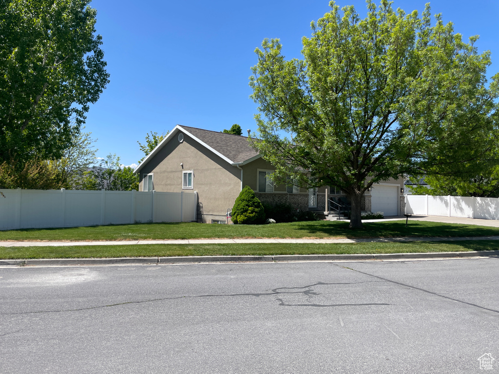 View of home\'s exterior featuring stucco siding and an attached garage
