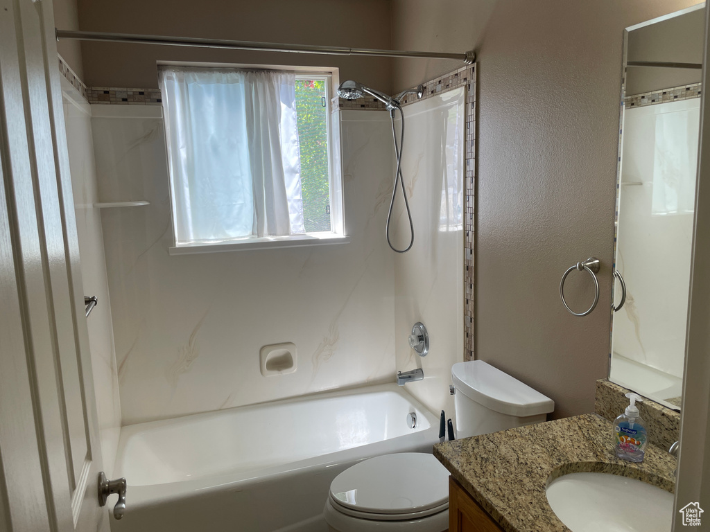 Full bath featuring toilet,  shower combination, and vanity