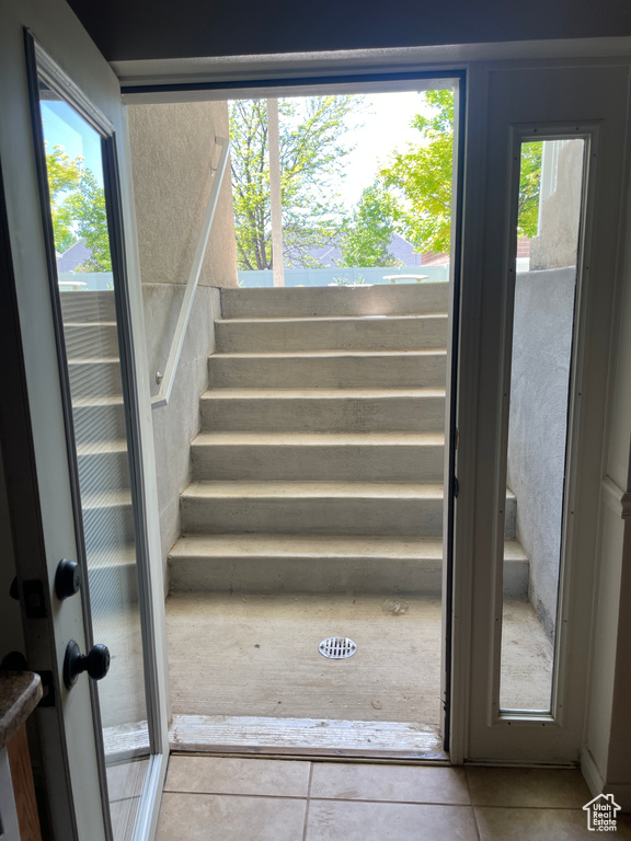 Stairs featuring tile patterned flooring