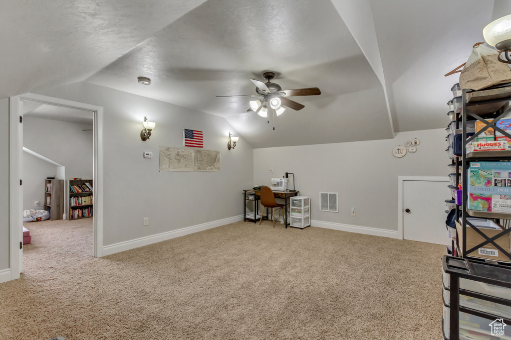 Bonus room with vaulted ceiling, carpet floors, ceiling fan, baseboards, and an office area