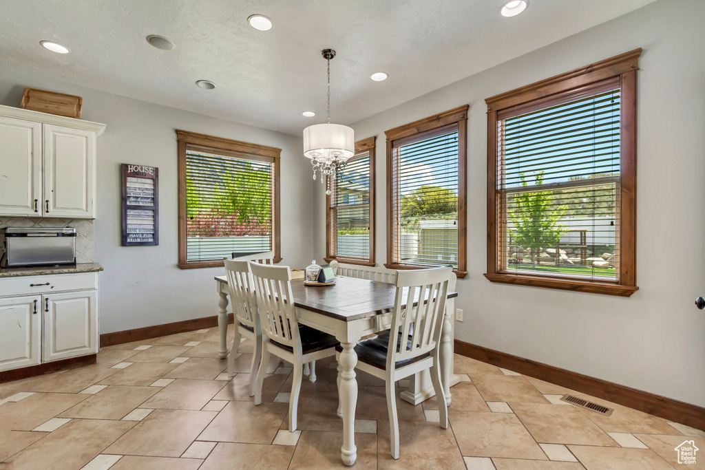 Dining area featuring baseboards, recessed lighting, a chandelier, and light tile patterned floors