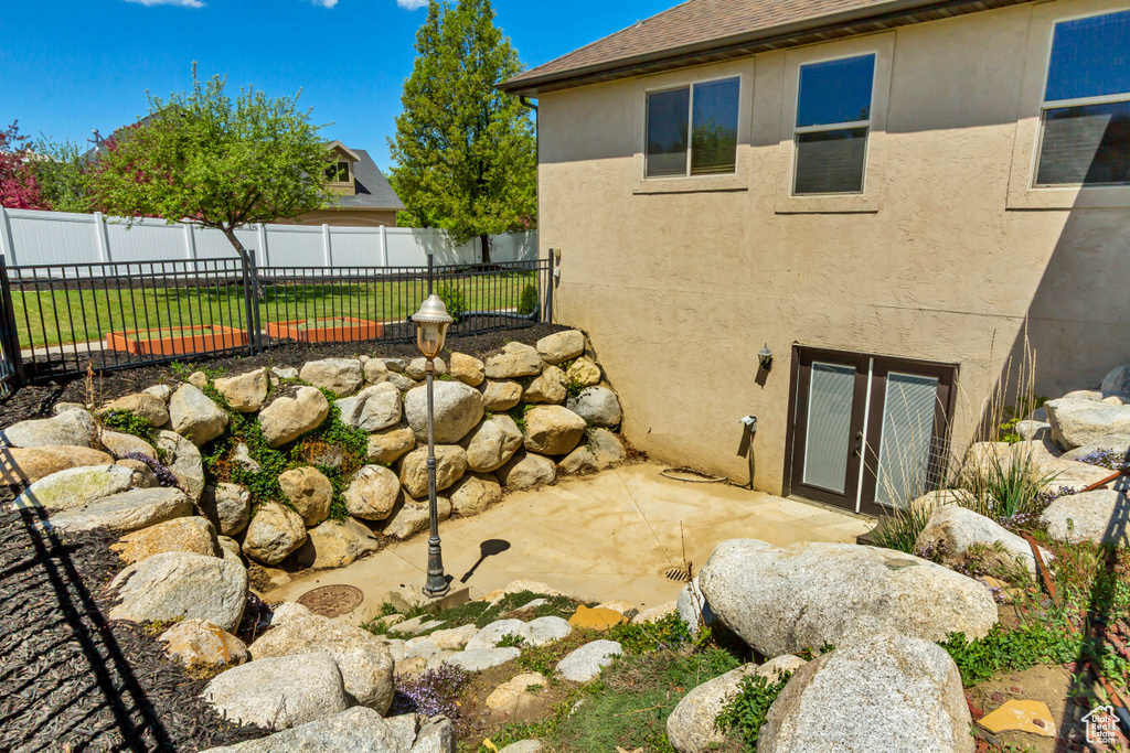 Exterior space featuring stucco siding and a patio