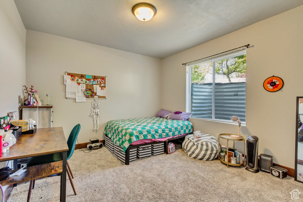 Bedroom featuring carpet and baseboards