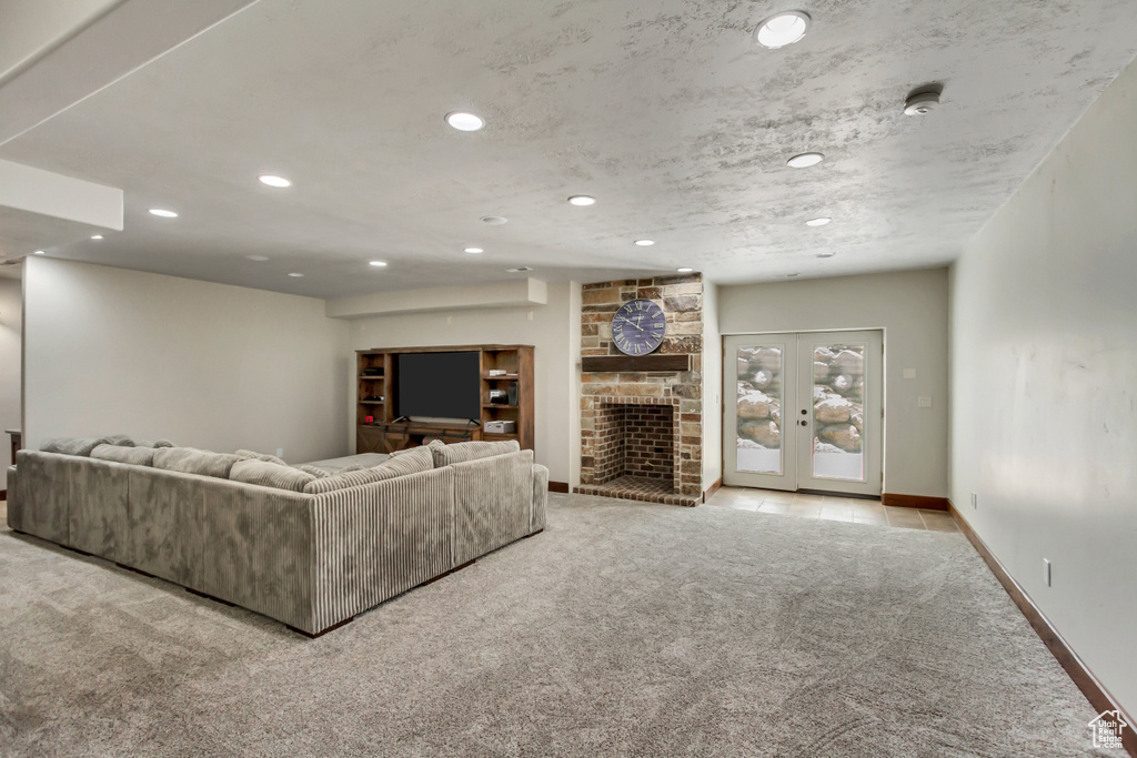 Living area with carpet, recessed lighting, a fireplace, and baseboards