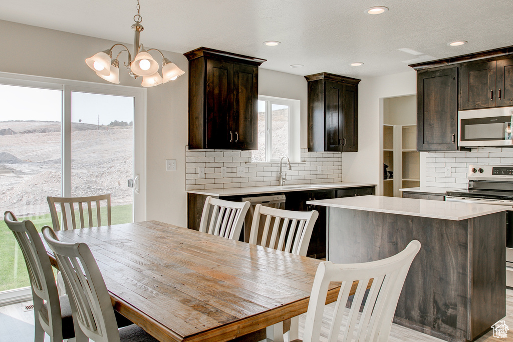 Dining space featuring a chandelier and recessed lighting