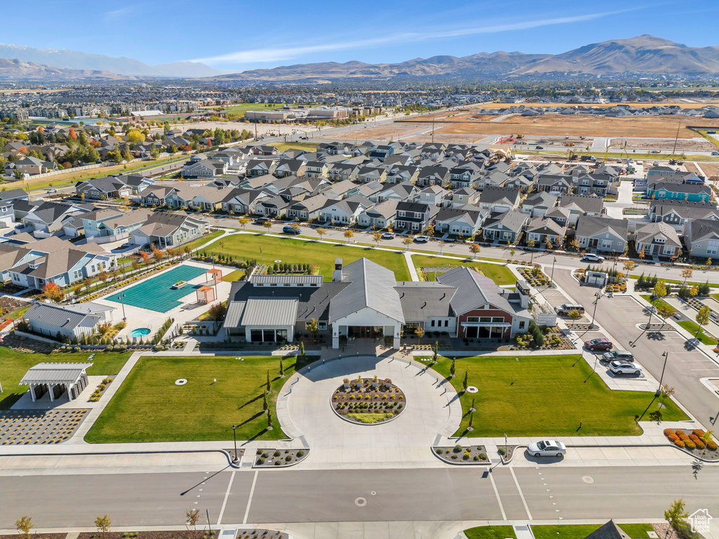 Aerial view of residential area with a pool area and a mountain backdrop
