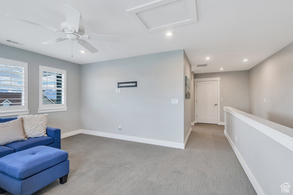 Living area with carpet floors, recessed lighting, baseboards, attic access, and ceiling fan