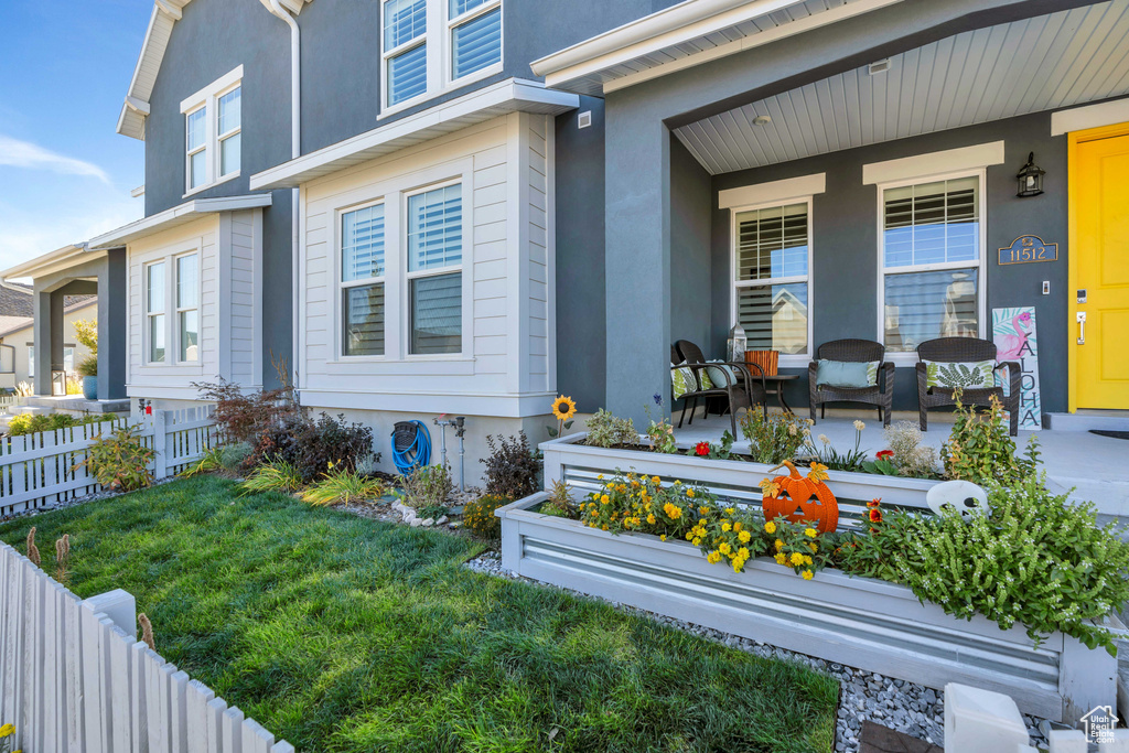 View of side of property with covered porch and stucco siding