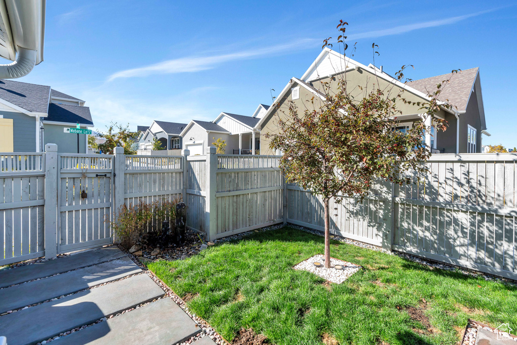 View of yard featuring a residential view and a gate