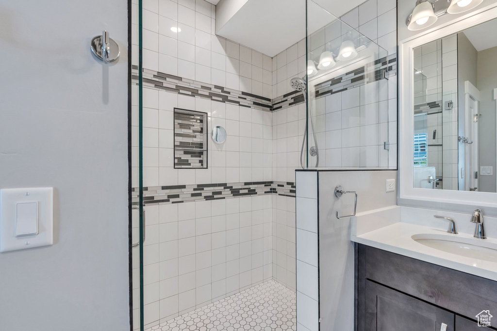 Full bathroom featuring tiled shower and vanity