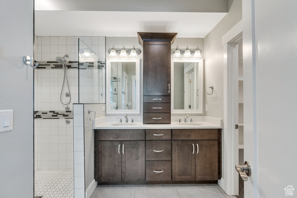 Full bathroom with walk in shower, tile patterned flooring, and double vanity