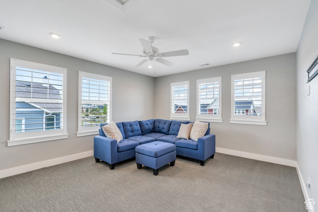 Living room with baseboards, light carpet, recessed lighting, and ceiling fan