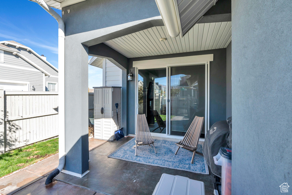 View of patio featuring fence