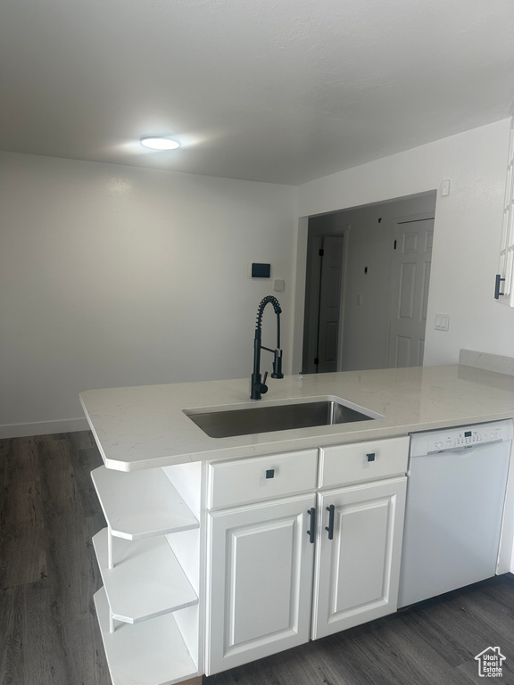 Kitchen with white dishwasher, a sink, open shelves, white cabinetry, and dark wood finished floors