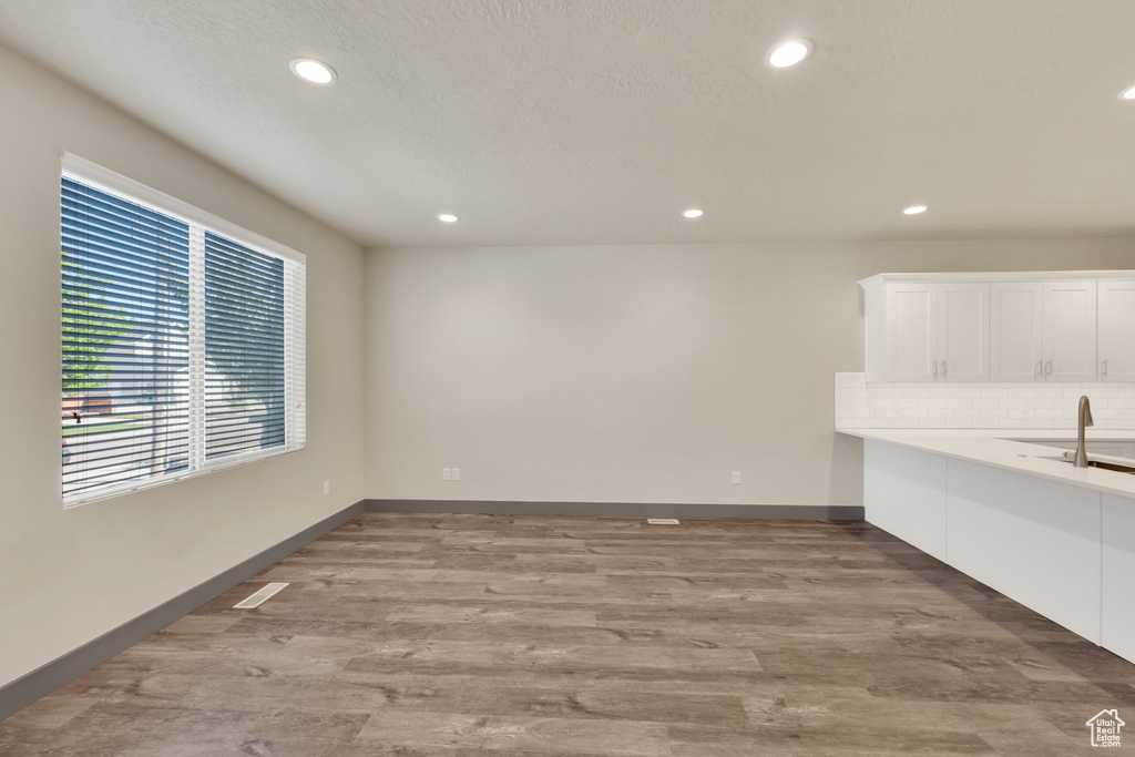 Unfurnished dining area featuring recessed lighting, wood finished floors, and baseboards