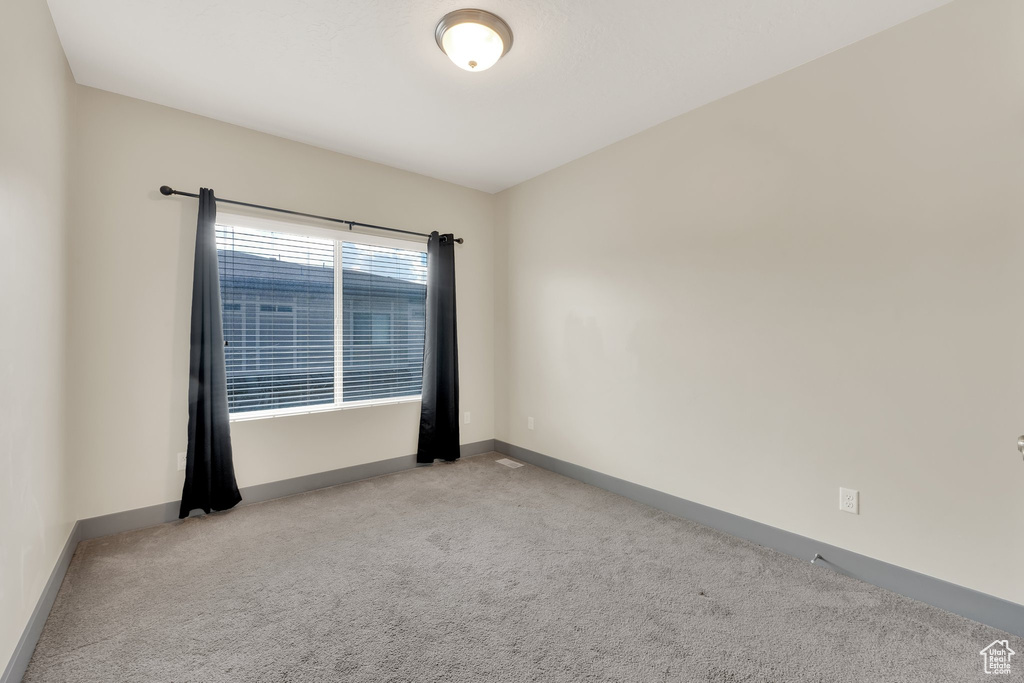 Unfurnished room featuring carpet flooring and baseboards