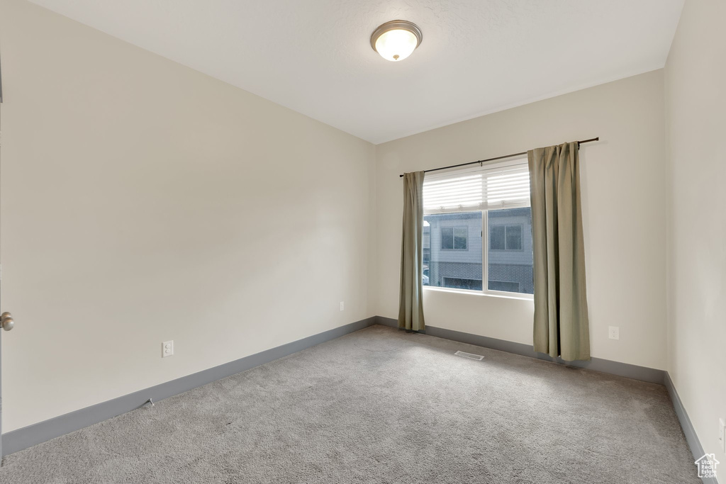 Unfurnished room with carpet and baseboards