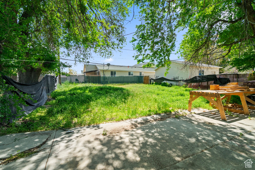 View of yard with a patio and fence