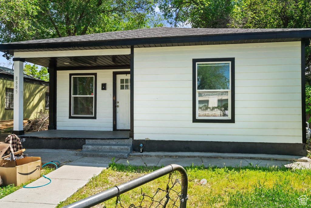 View of front of property featuring covered porch and roof with shingles