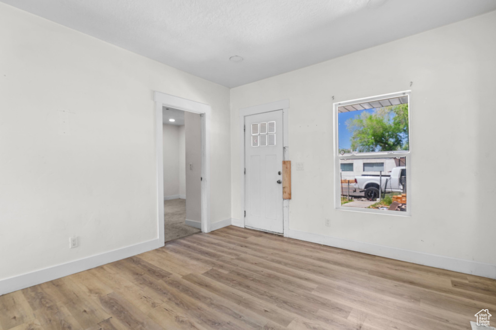 Unfurnished room with wood finished floors and baseboards