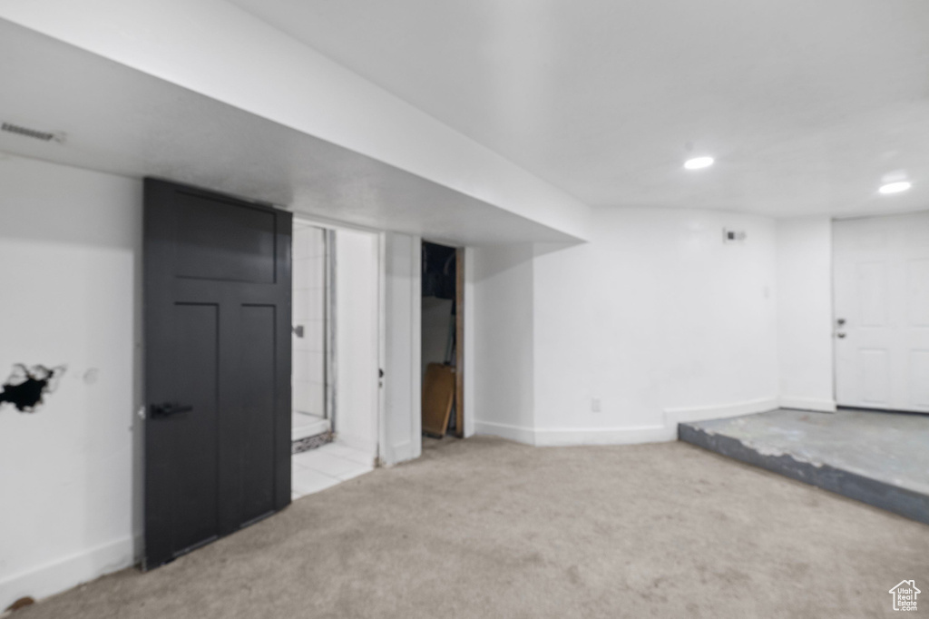 Finished below grade area with carpet floors, recessed lighting, and baseboards