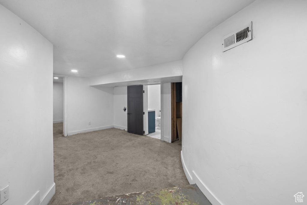Finished below grade area with baseboards, recessed lighting, and carpet flooring