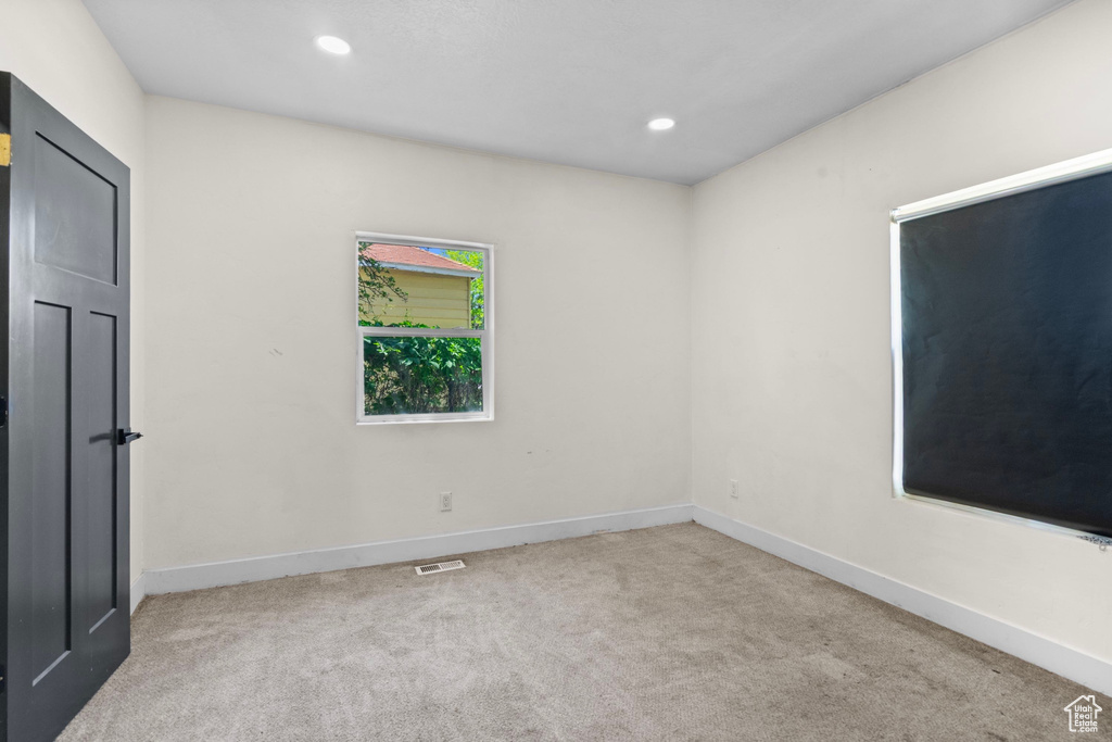Carpeted empty room featuring baseboards and recessed lighting