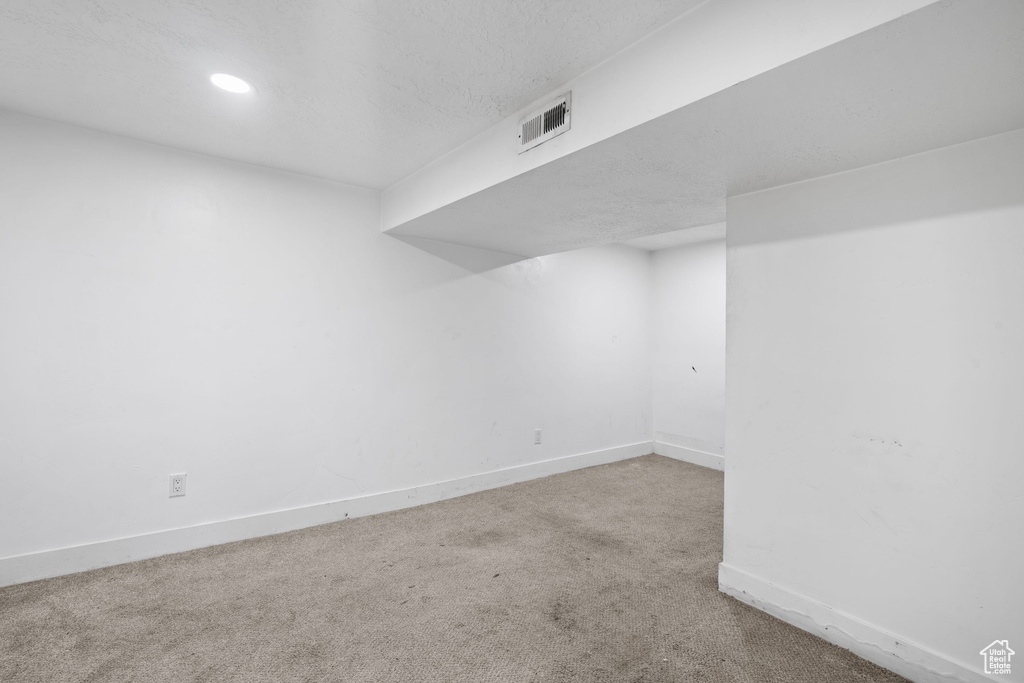 Finished below grade area with carpet floors, baseboards, and recessed lighting
