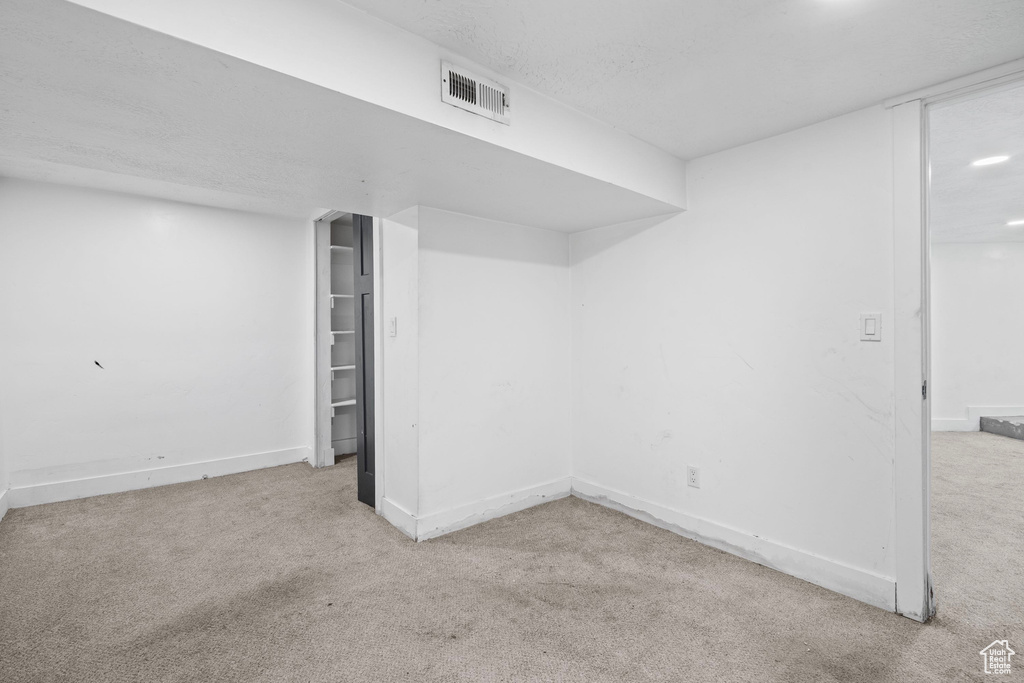 Finished basement with carpet and baseboards