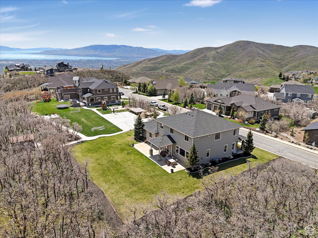 Aerial view of residential area featuring a mountainous background