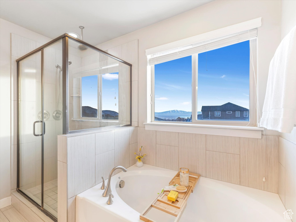 Bathroom with a shower stall and a garden tub