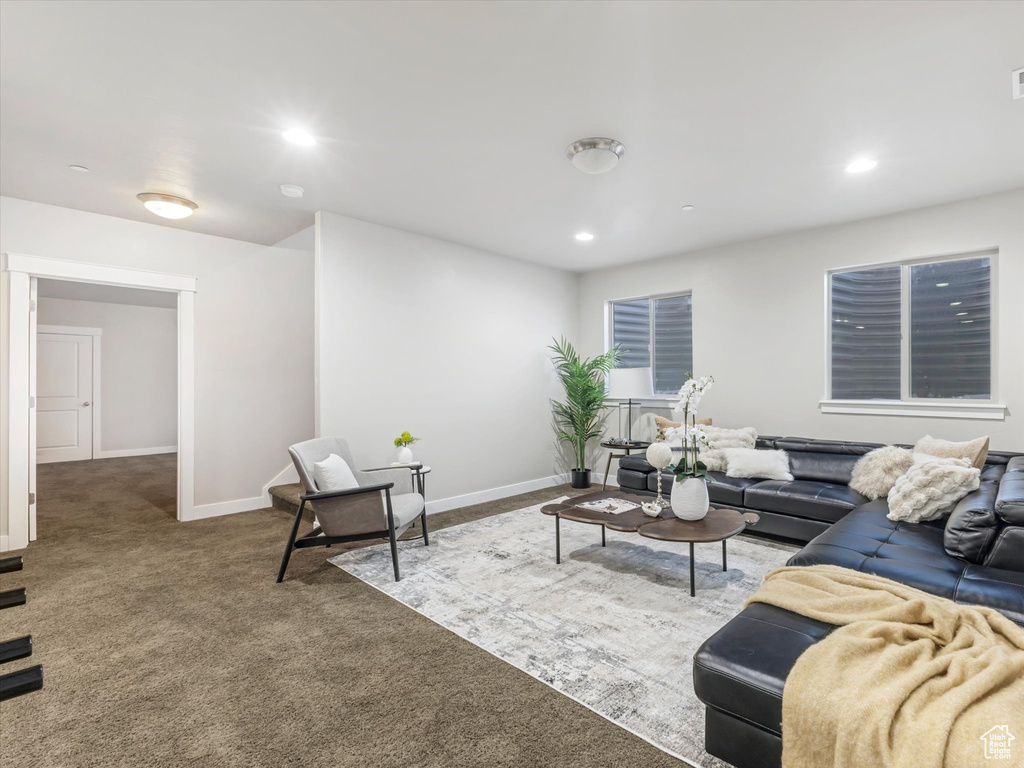 Carpeted living area featuring baseboards and recessed lighting