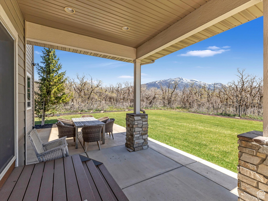 View of patio featuring outdoor dining space and a mountain view