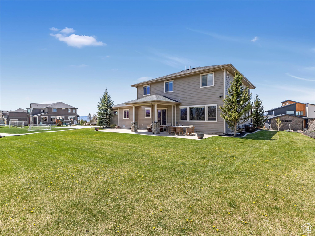 Back of property featuring a patio area and a yard