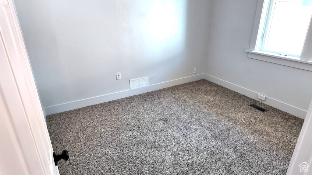 Unfurnished room with carpet floors and baseboards
