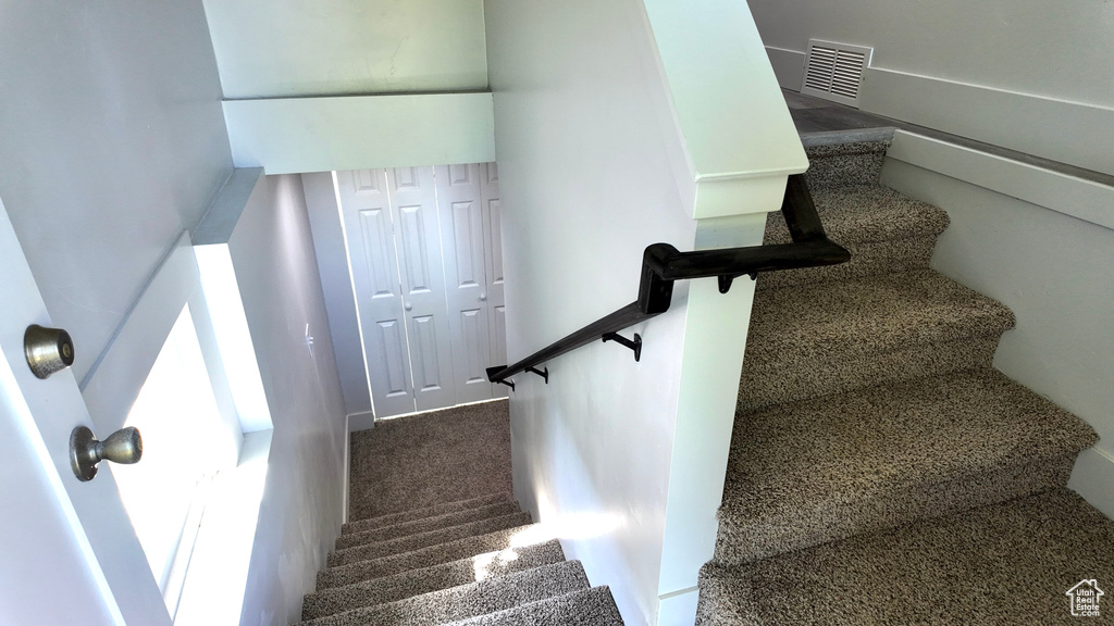 Stairway featuring carpet