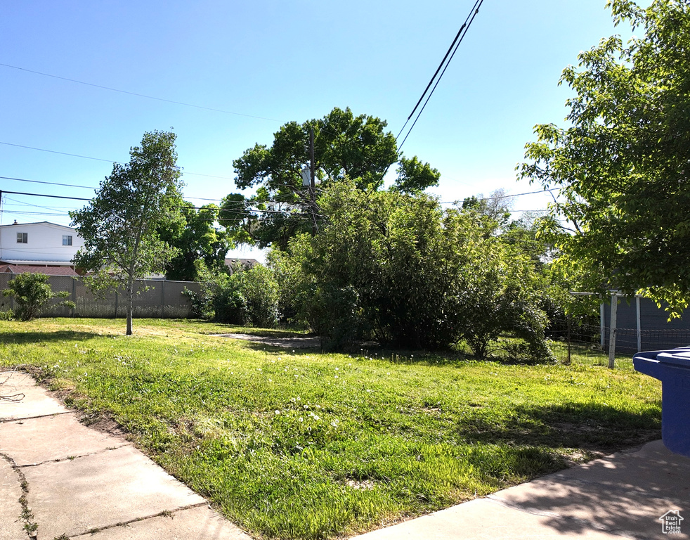 View of yard featuring fence