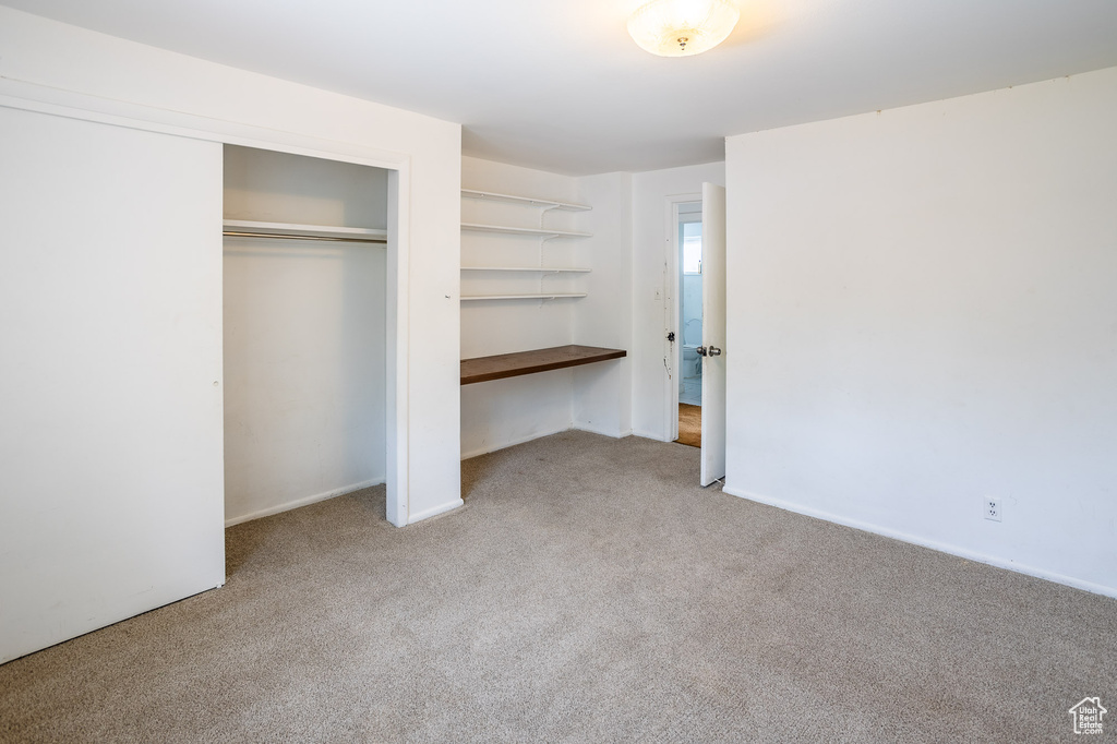 Unfurnished bedroom with carpet floors and a closet