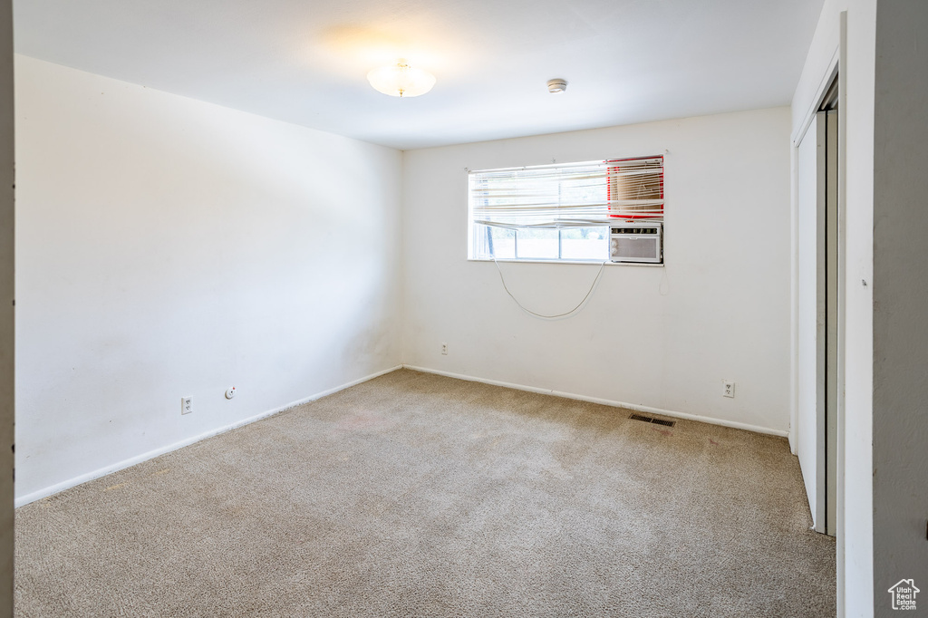 Unfurnished room with carpet floors, baseboards, and a smoke detector