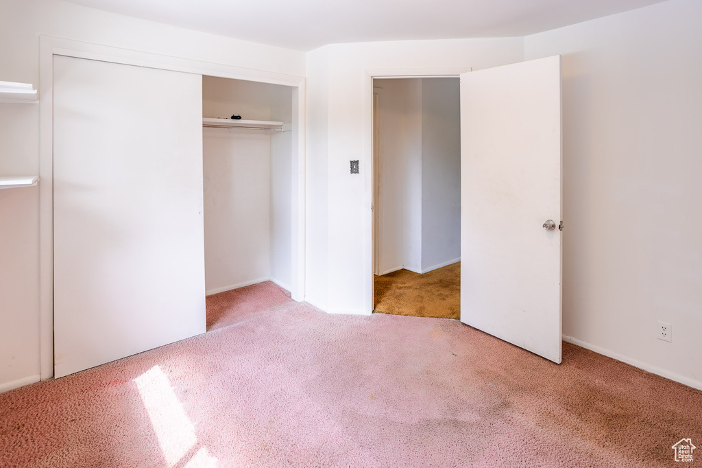 Unfurnished bedroom with carpet flooring and a closet