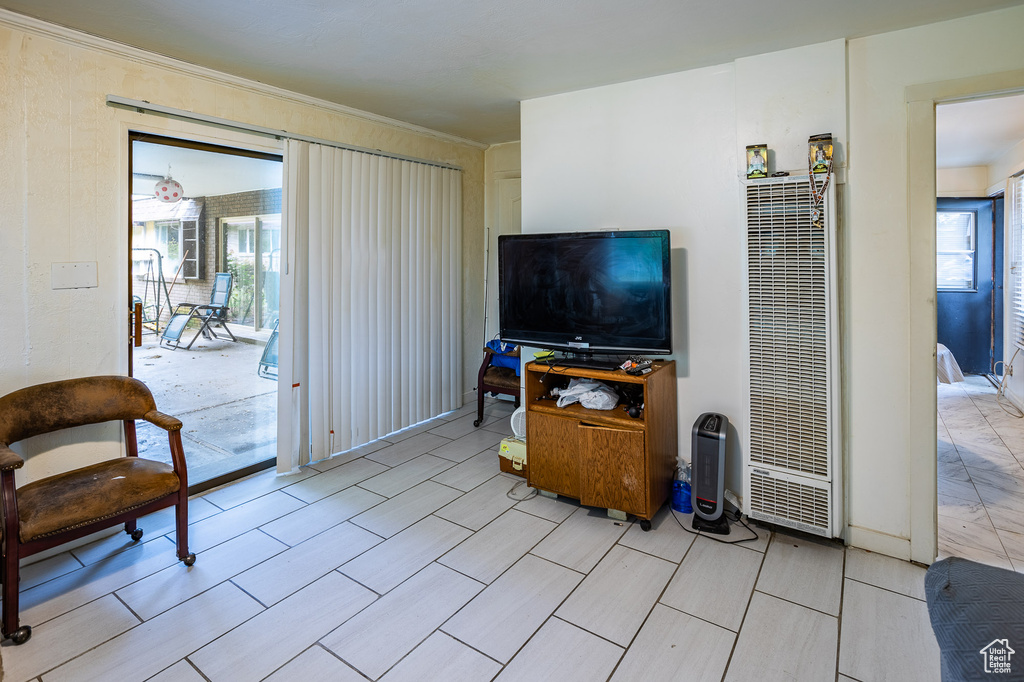 Living room with a heating unit and crown molding