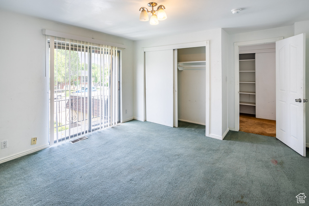 Unfurnished bedroom with carpet, access to outside, a closet, and baseboards
