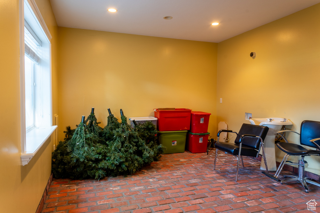 Misc room featuring plenty of natural light, brick floors, and recessed lighting