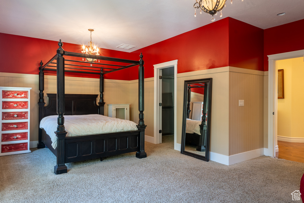 Bedroom with a chandelier and carpet