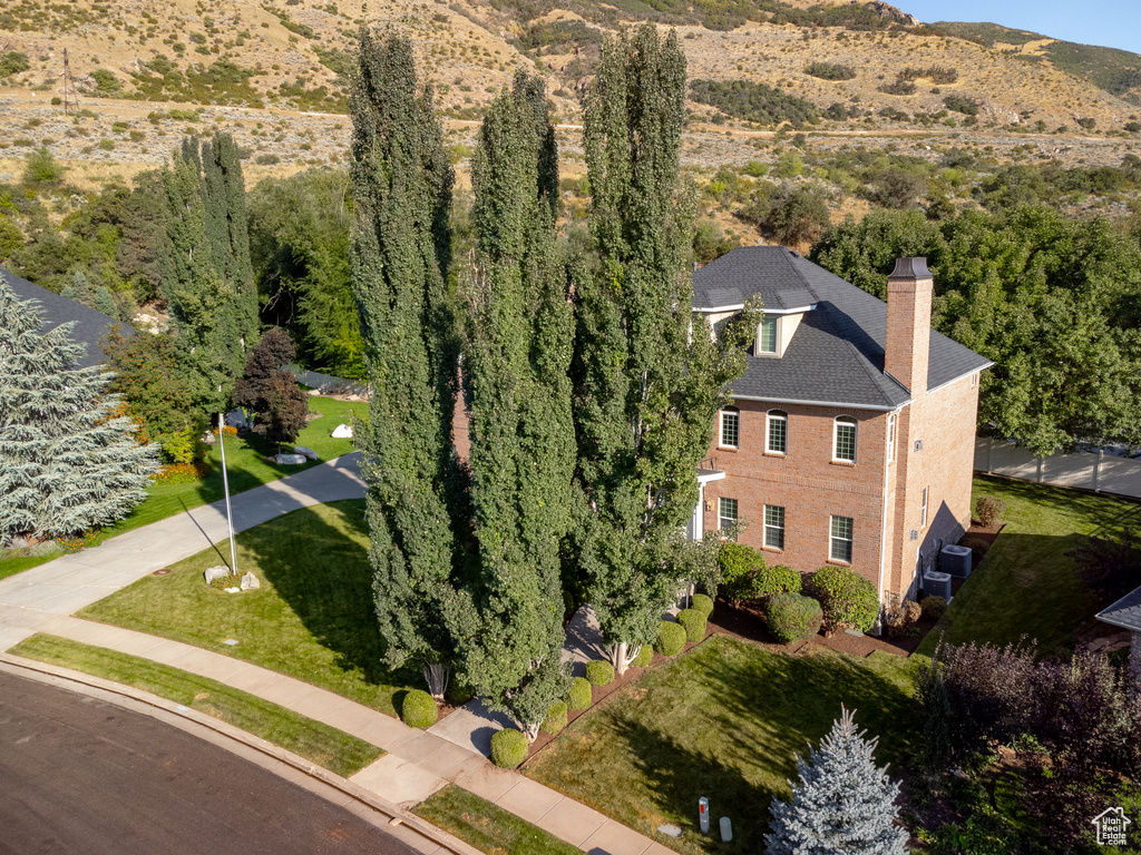 Aerial view of property and surrounding area with mountains