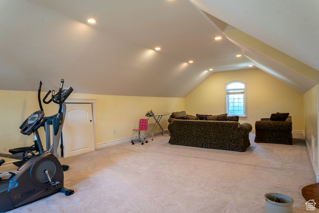 Workout area with lofted ceiling, carpet flooring, baseboards, and recessed lighting